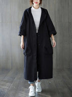 Damen langer Oversized-Kapuzen-Trenchcoat mit wasserabweisendem Material und aufgesetzten Taschen